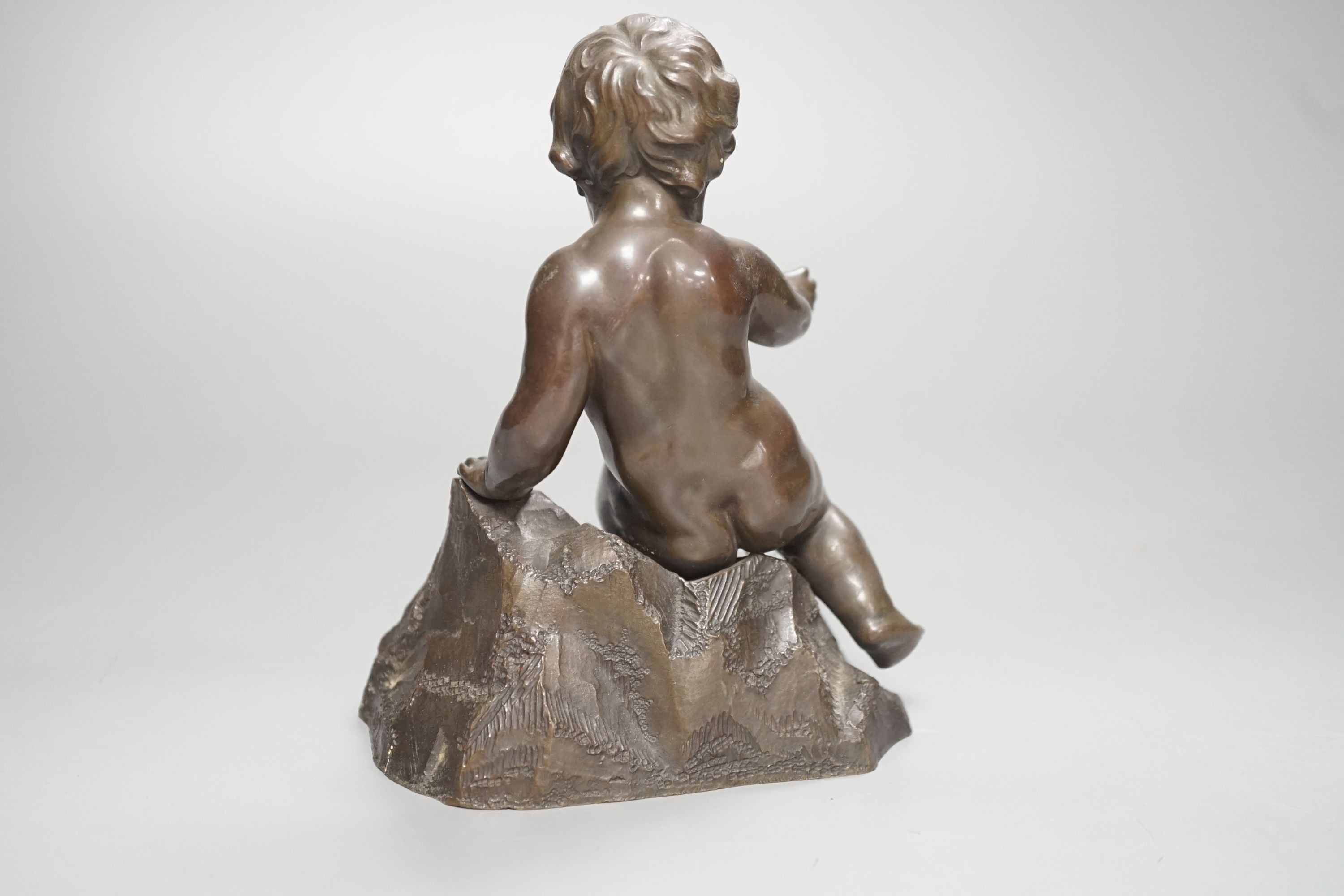 A bronze of a seated boy, height 17cm